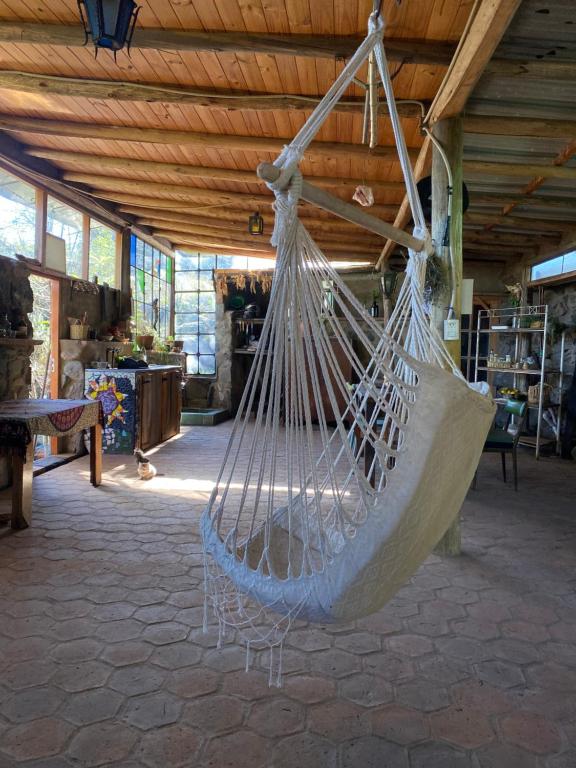 a hammock hanging from a ceiling in a room at Refugio La Paciencia in Travesía