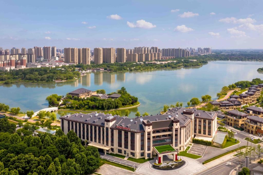 an aerial view of a building next to a body of water at Mövenpick Kaifeng West Lake in Kaifeng