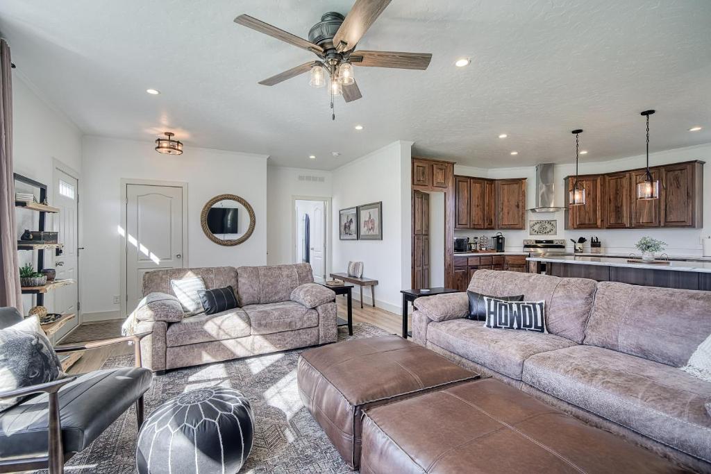a living room with two couches and a ceiling fan at 3 King Beds Spacious 4 BR 3 BATH AC Near Jackson in Victor