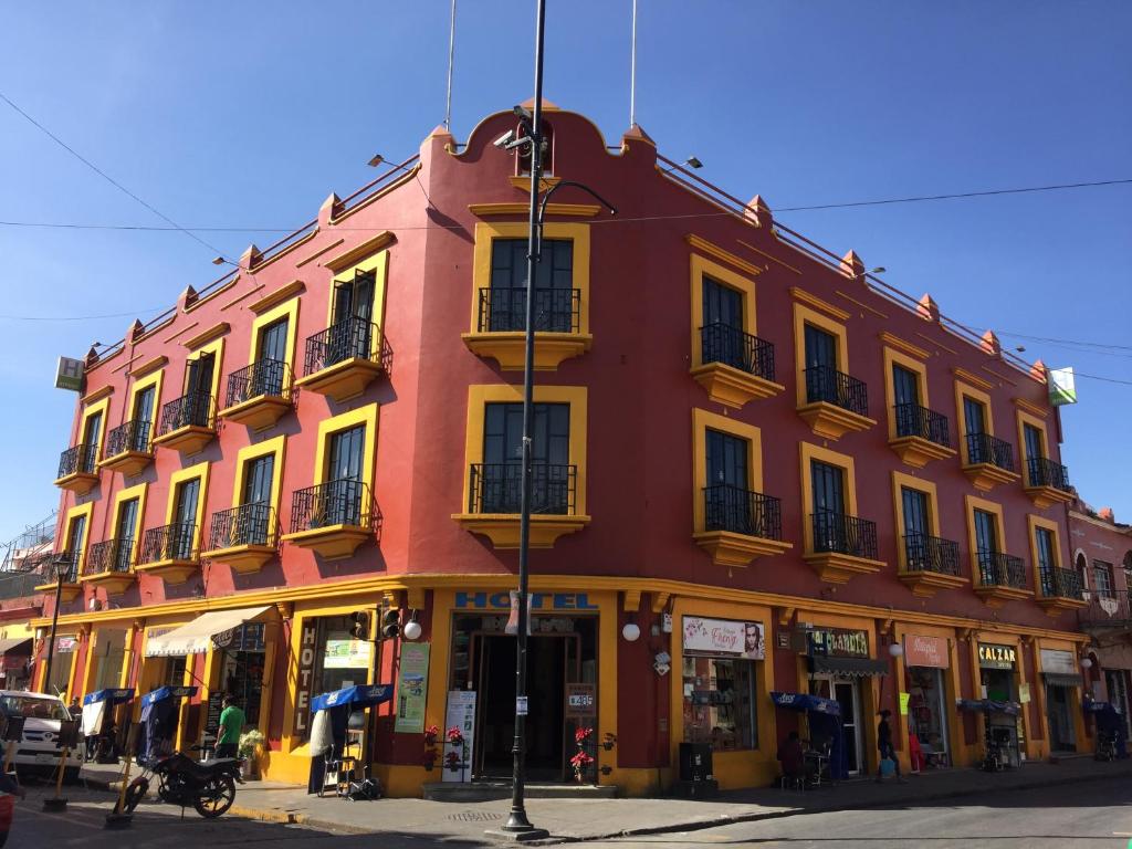 a large red building on a city street at Hotel Rivera in Oaxaca City
