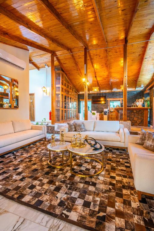 a living room with white couches and a table at Hotel Dorys de Lourdes in Pisco Elqui