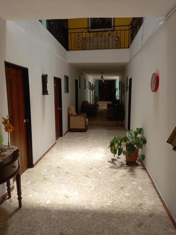 a hallway with a living room with a couch at Hotel Oriente Real in Rionegro