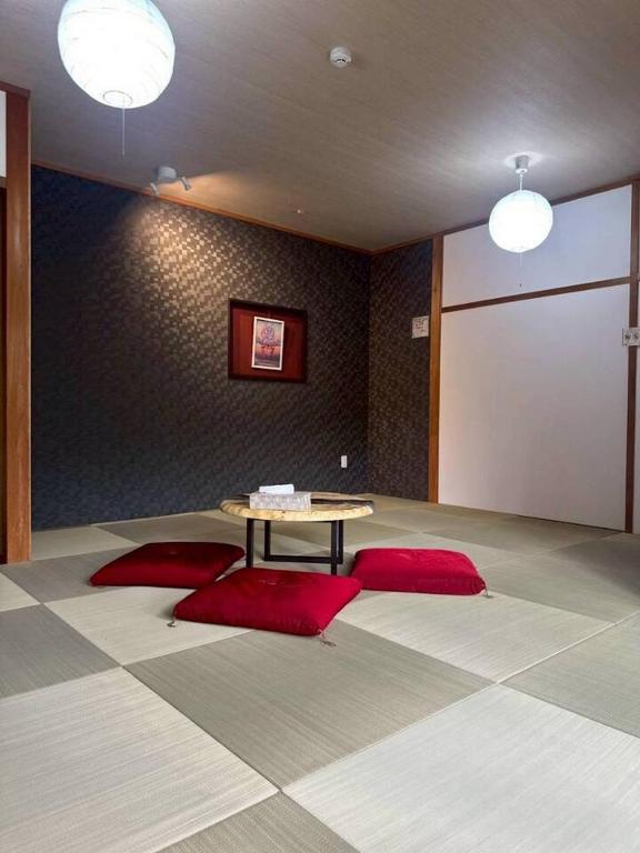 a room with a table in the middle of a room at Folk-ish Style 風 in Miyazu