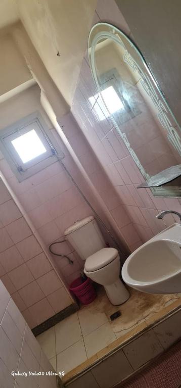 a bathroom with a toilet and a sink at Meknes Hamria centre ville in Meknès