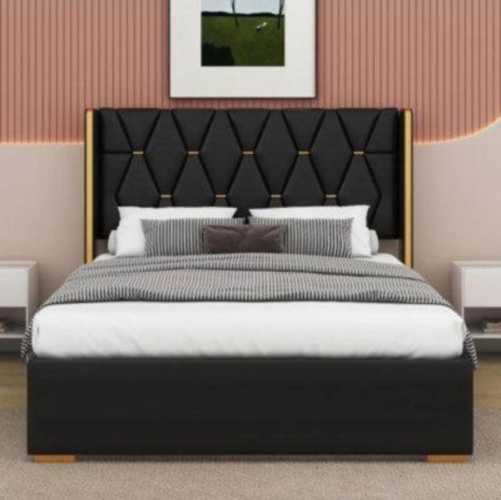 a bedroom with a large bed with a black headboard at Hotel Ravi Park Lahore in Lahore