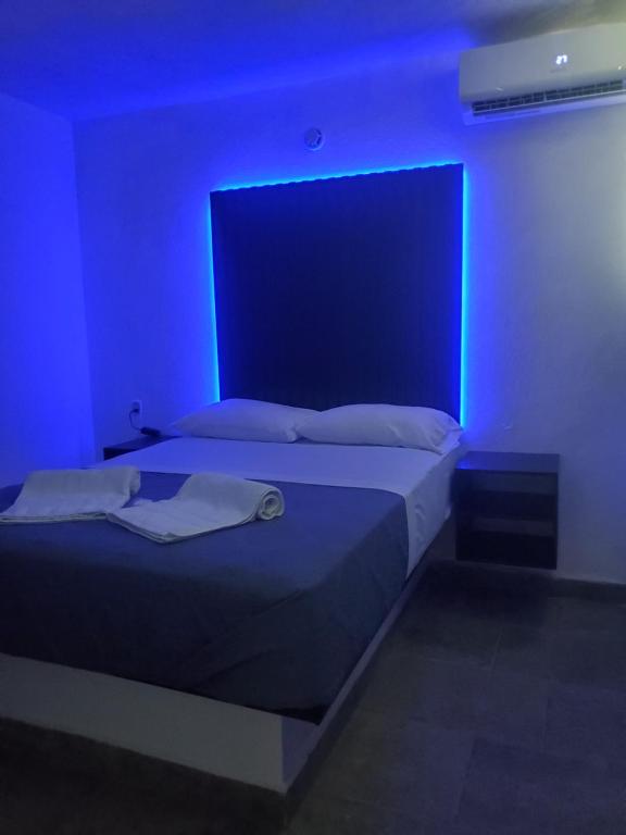 a bedroom with a bed with a blue light at Lacosta Josss in Acapulco