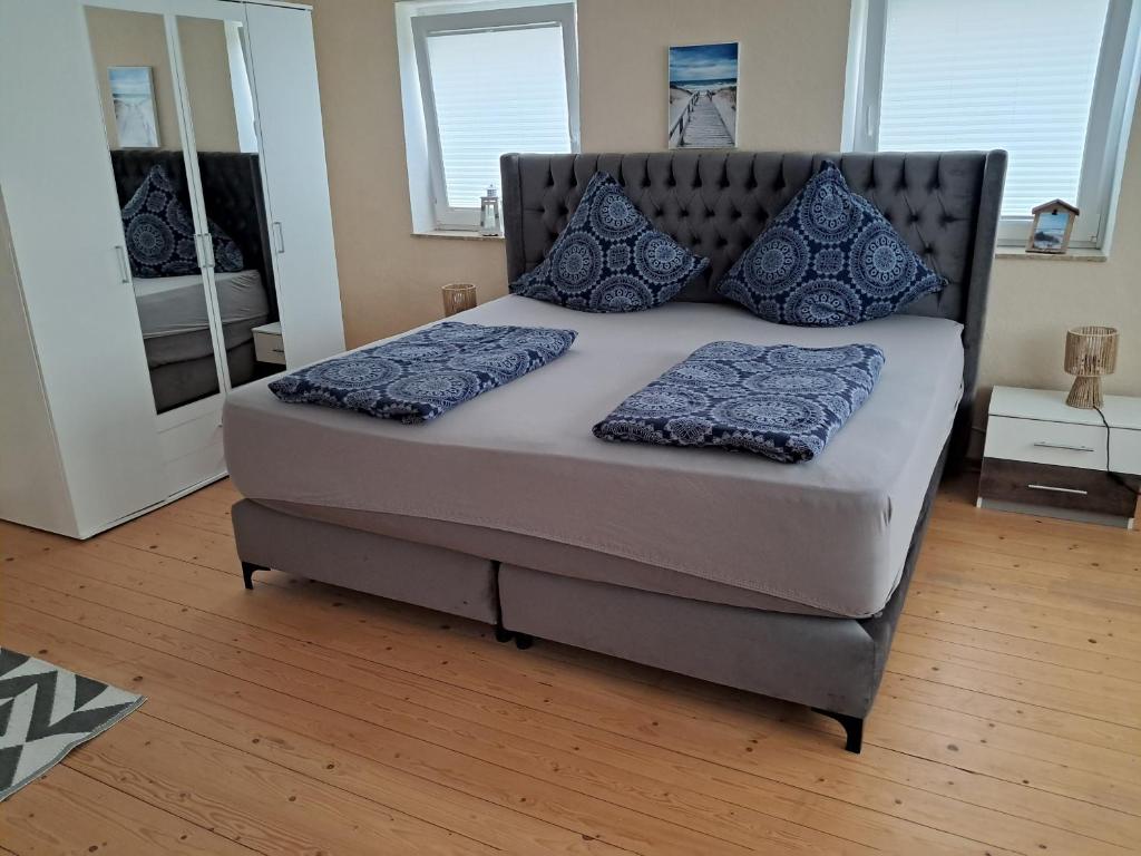 a bed with blue pillows on it in a bedroom at MäuseScheune in Sankt Annen