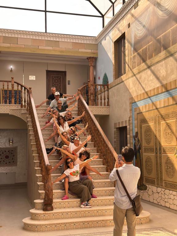 a group of people sitting on the stairs of a building at Art Minor Khiva in Khiva