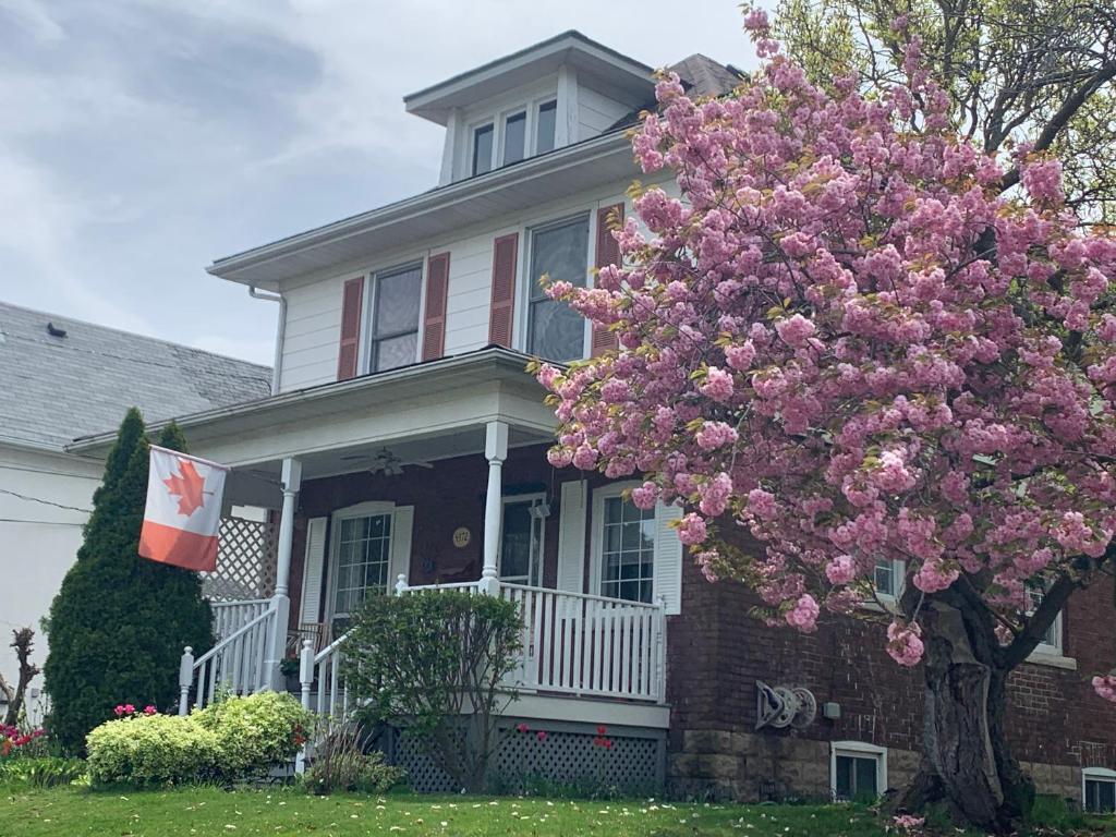 a house with a flowering tree in front of it at Strathaird Bed and Breakfast in Niagara Falls