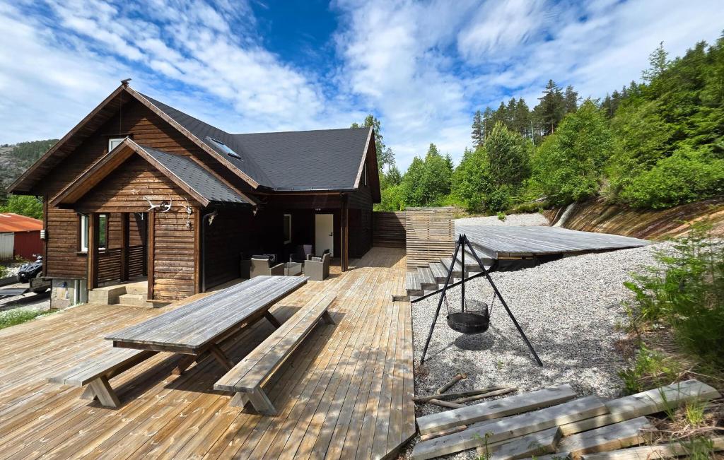 a wooden deck with a bench and a building at Stunning Home In Treungen in Treungen