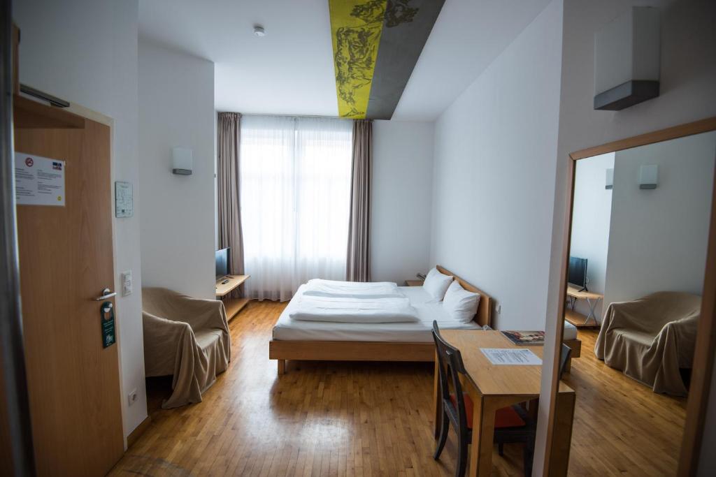 Postel nebo postele na pokoji v ubytování Art-Hotel Robert Mayer