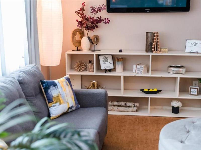 a living room with a couch and a tv on a shelf at All About Alaska in Anchorage