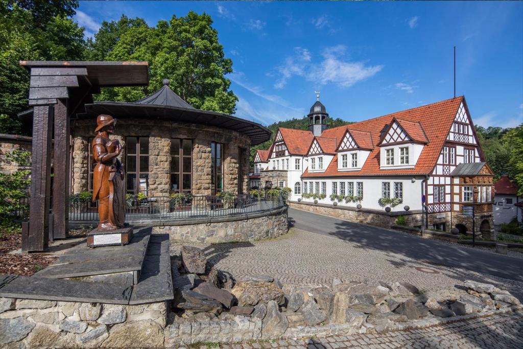 a statue of a man in front of a building at Hotel Anker in Saalfeld