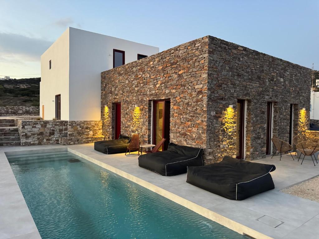 a house with a swimming pool next to a building at Antiparos Gems - The villa in Antiparos