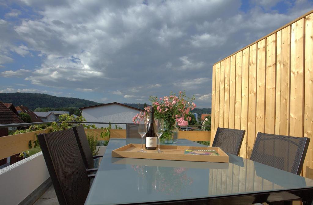 a bottle of wine sitting on a table on a balcony at Trüffelhof 1 in Bodman-Ludwigshafen
