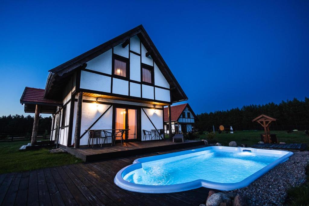 a house with a swimming pool in front of it at Klinwdzydze in Wdzydze Tucholskie