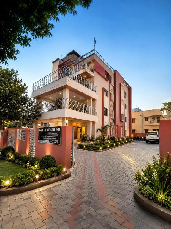 a building with a parking lot in front of it at Hotel Crystal INN in Bhubaneshwar