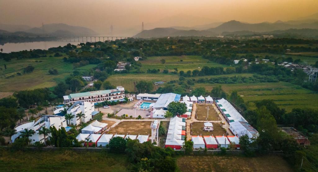 an aerial view of a farm near a river at Vasant Vihar Resort in Kevadia