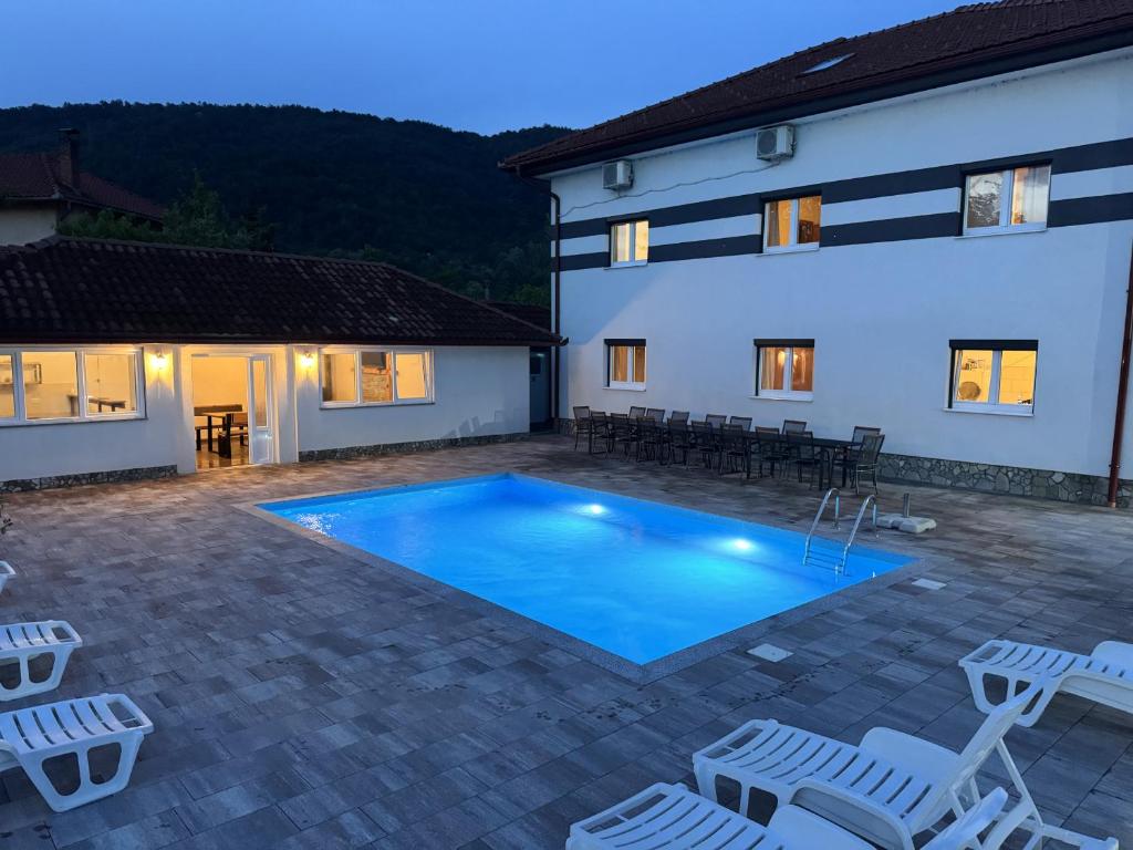 a villa with a swimming pool at night at Althea Home & Wellness in Bihać