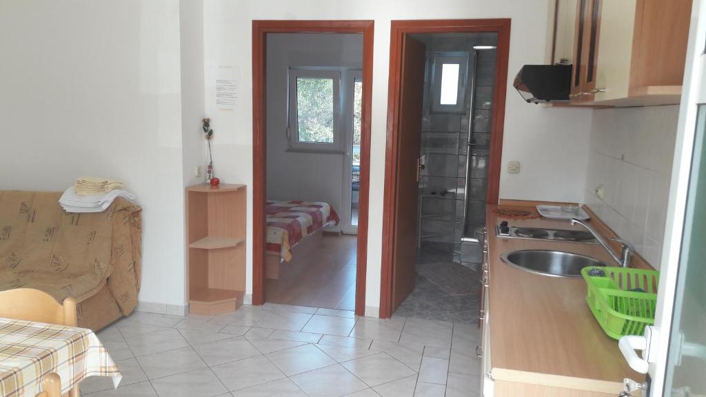 a small kitchen with a sink and a bathroom at Apartments Irena in Božava