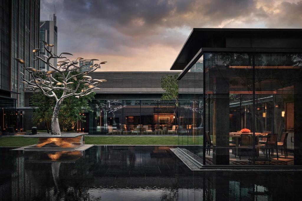 a house with a tree in front of a building at Alila Shanghai in Shanghai