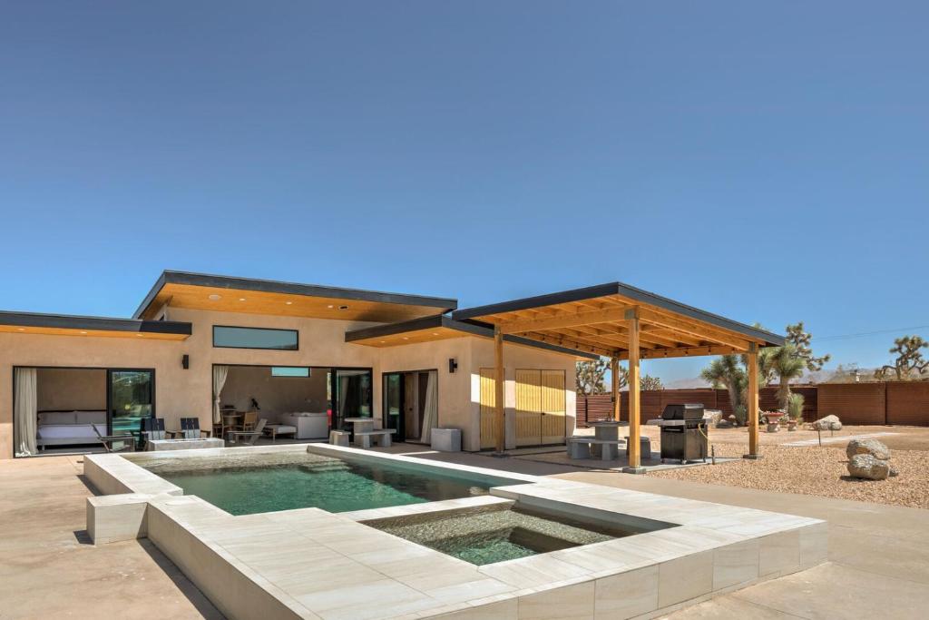 a house with a swimming pool in the yard at Sand Tulum Retreat w Pool Spa in Yucca Valley