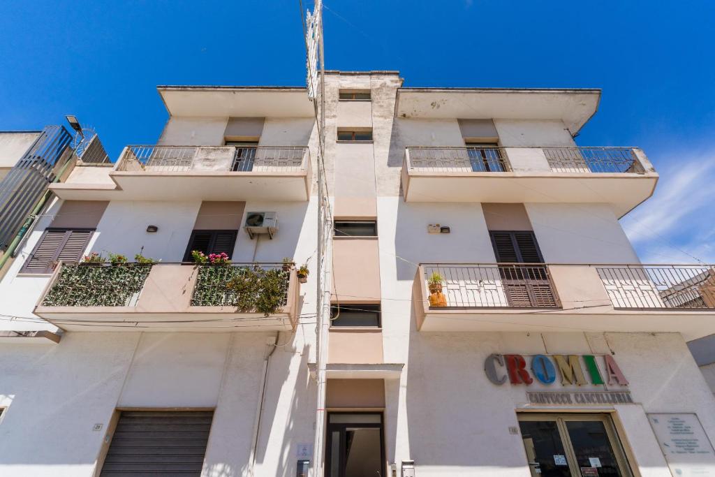 a tall white building with balconies at Al Calico in Galatone