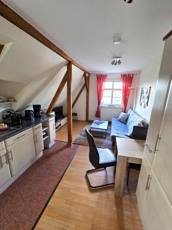 a kitchen and living room with a couch and a table at Ferienwohnung Knoth in Altenburg