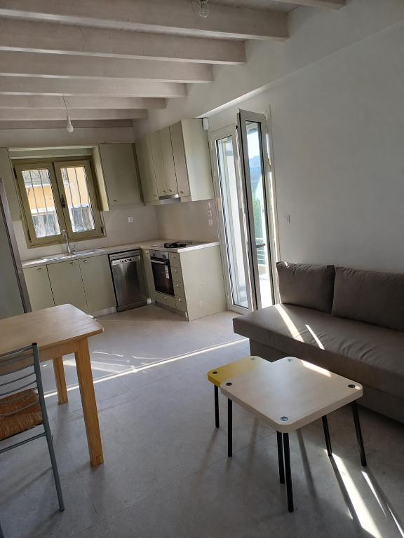 a living room with a couch and a table at Valimitika beach house - Just 150m from the beach in Valimítika