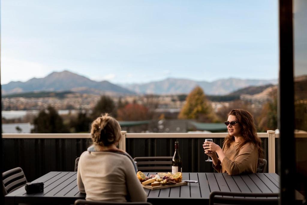 two women sitting at a table with a plate of food at Tasman Holiday Parks - Wanaka in Wanaka