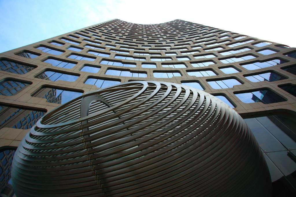 a tall building with a circular design on it at Andaz Xintiandi, Shanghai, By Hyatt in Shanghai