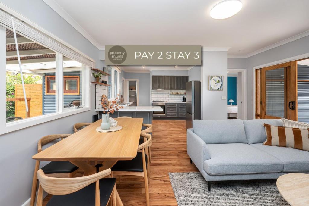 a living room with a table and a couch at Dixie by Property Mums in Rye