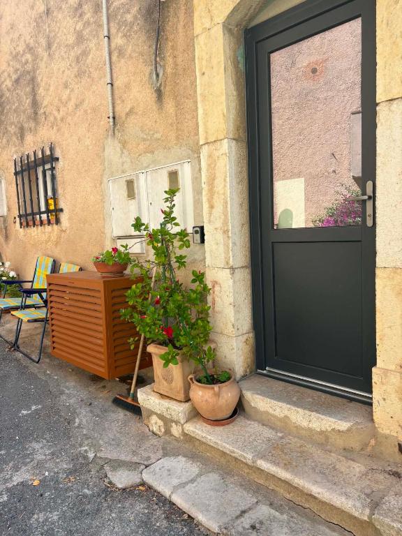 a door of a building with potted plants on the steps at Bella Vista Cabris in Cabris