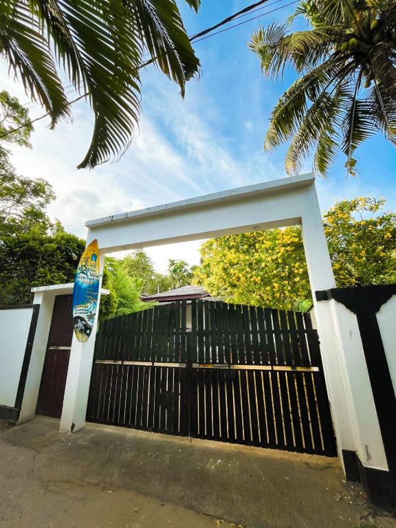 a gate to a house with a skateboard on it at Bule Bells Villa in Matara