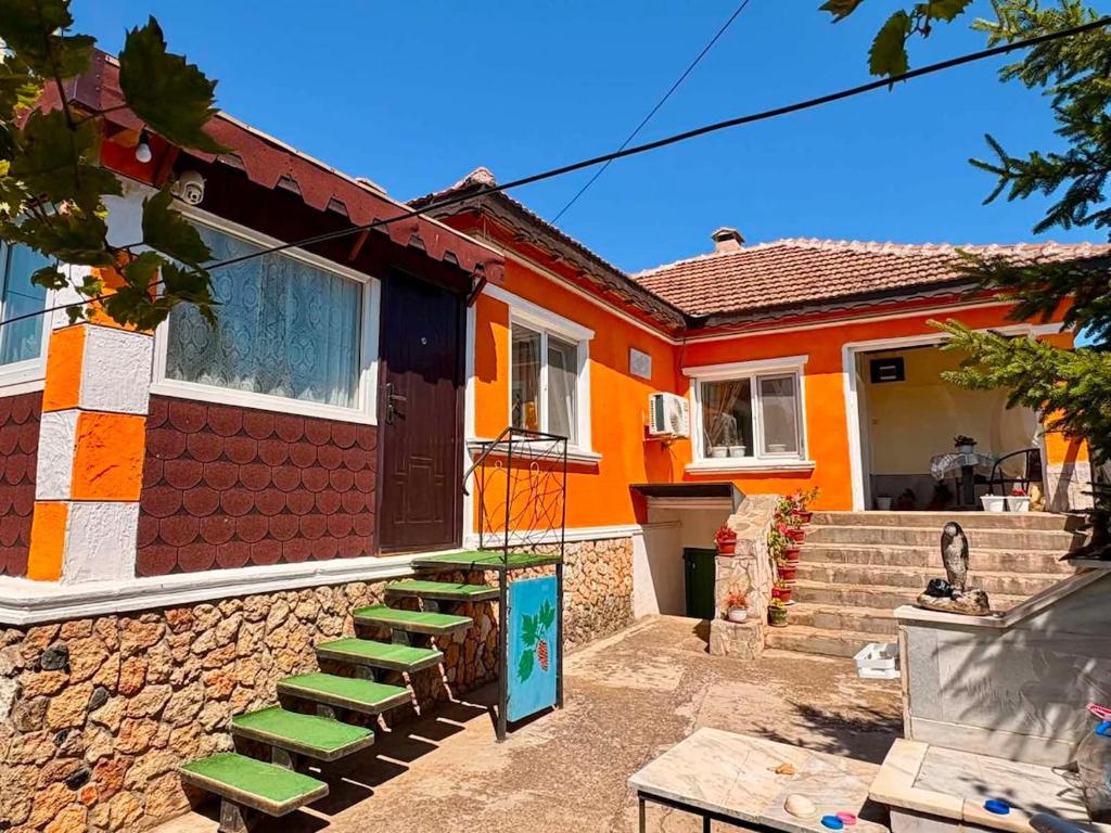 a house with a set of stairs in front of it at Rapan Guesthouse in Bŭlgarevo