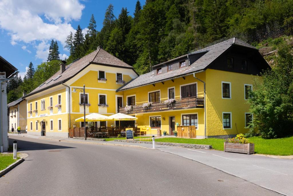 a large yellow building on the side of a road at Der Thomataler Wirt in Thomatal