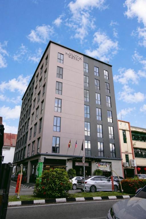 a building with a car parked in front of it at Meritin Hotel in Kuching