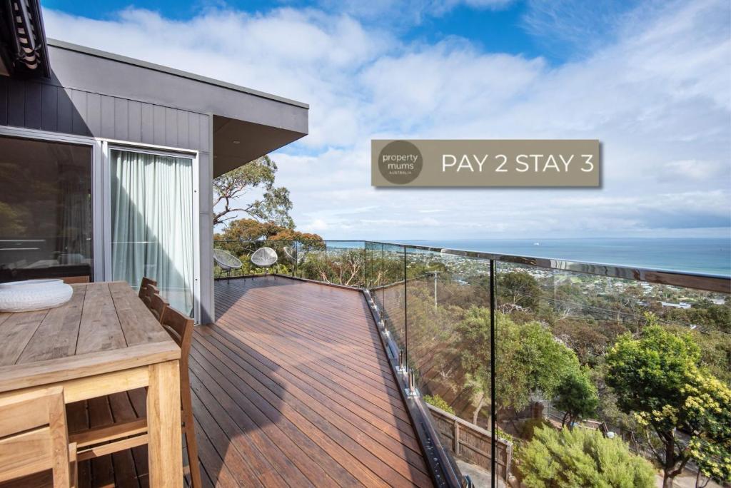 a balcony with a view of the ocean at Cook's Lookout McCrae in McCrae