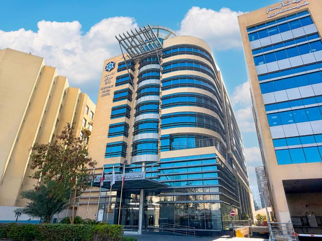 a large office building with a lot of windows at Sapphire Plaza Hotel in Doha