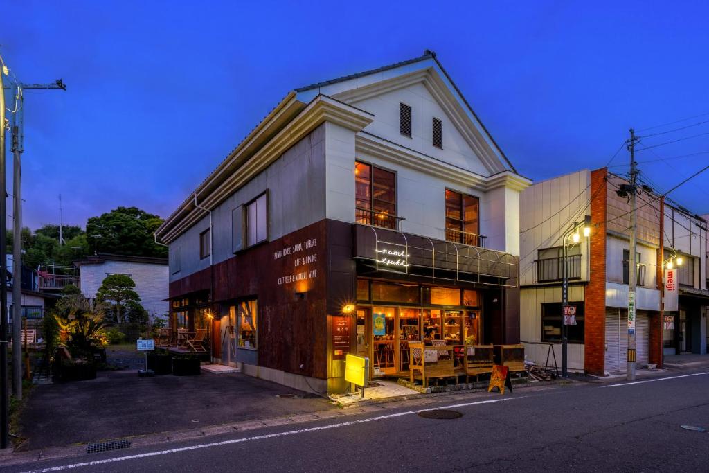 a building on a city street at night at 波と月 in Oarai