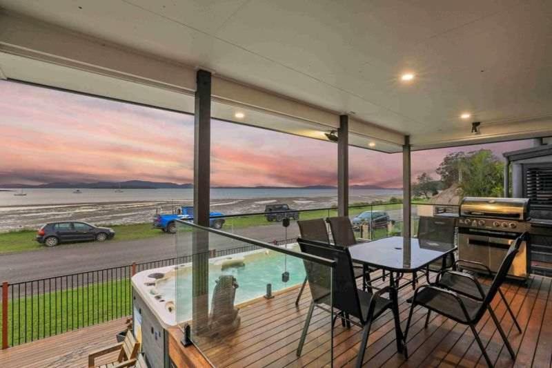 a house with a balcony with a view of the ocean at Marea at Tanilba Bay in Lemon Tree Passage