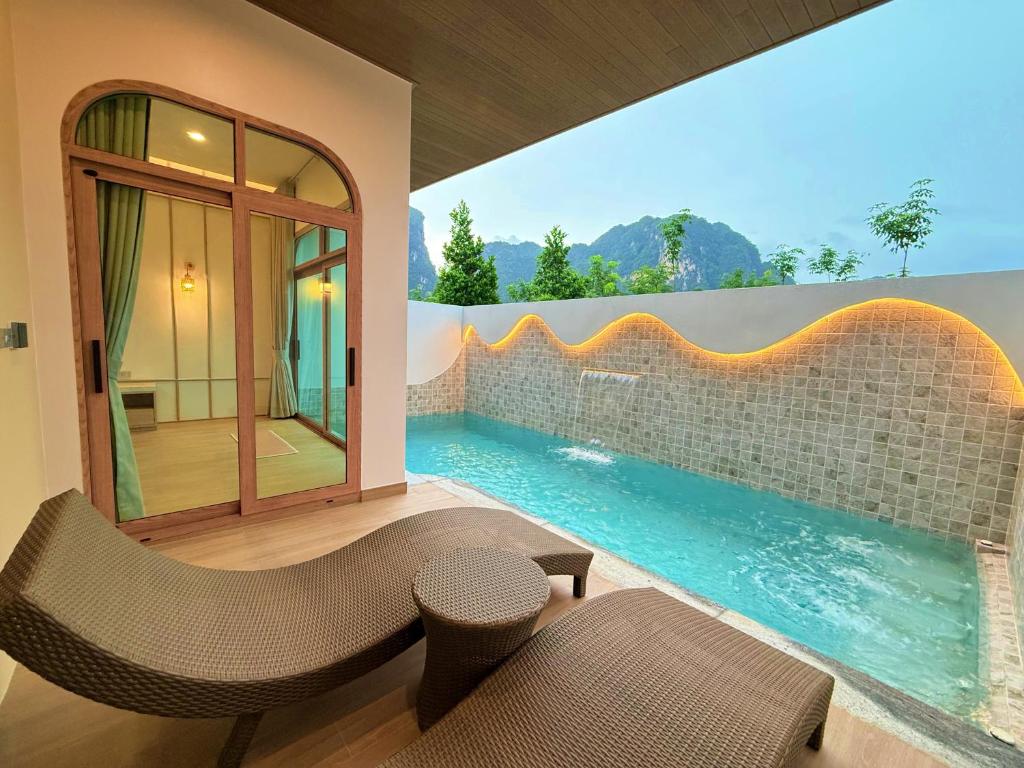 a swimming pool with a view of a house at The Apex private pool villa Krabi in Krabi