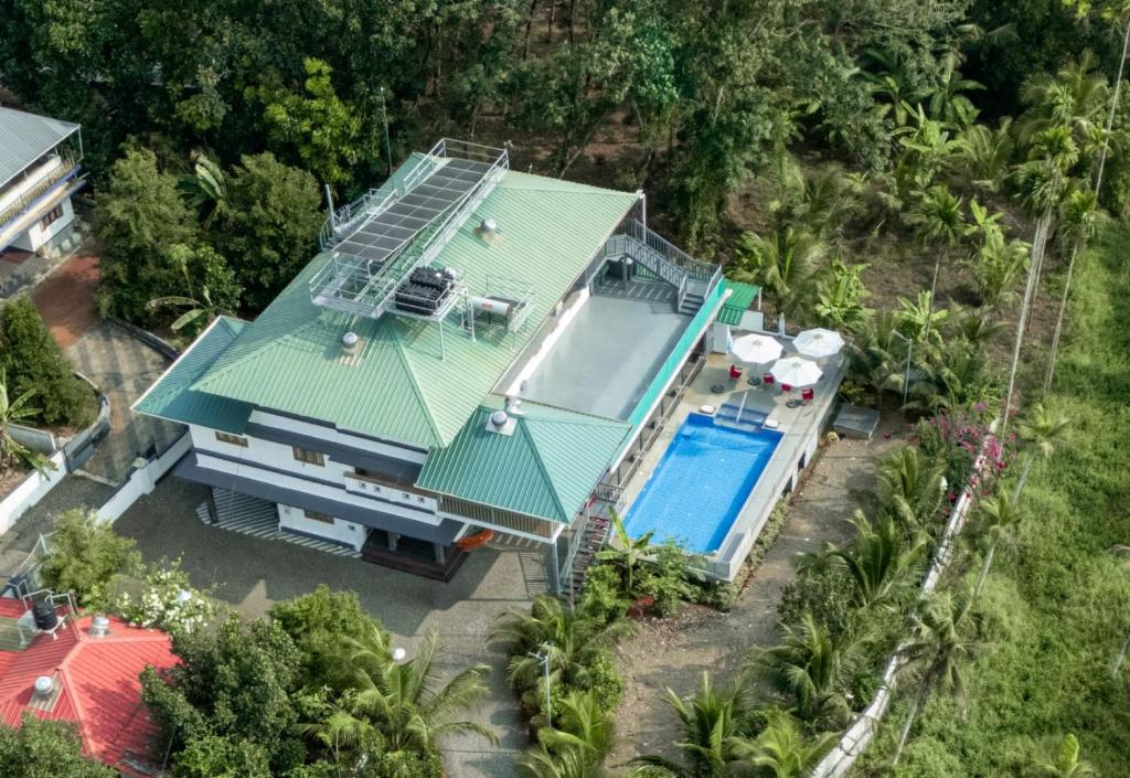 an aerial view of a house with a swimming pool at BIKI'S PALM VILLA in Kaduturutti