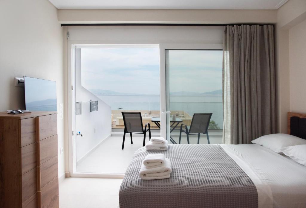 a bedroom with a bed and a table with chairs at Virea VA Complex in Vaia