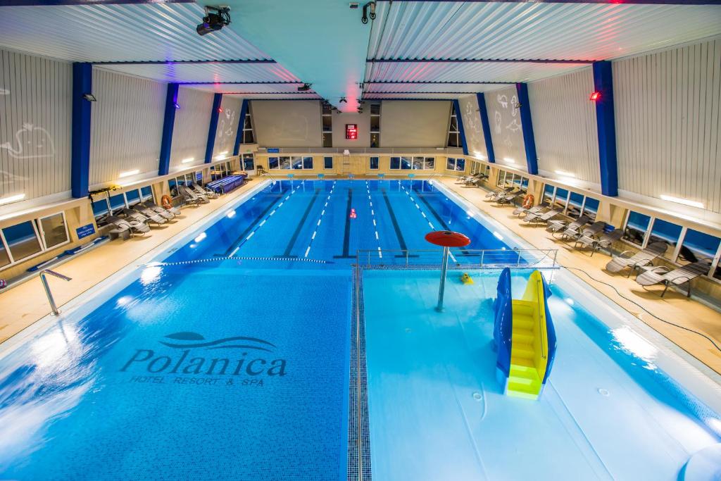 a large swimming pool in a large room at Hotel Polanica Resort & Spa in Polanica-Zdrój