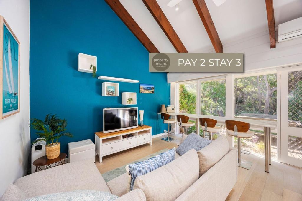 a living room with a couch and a tv at Captain Sandy on the Loop Blairgowrie in Blairgowrie