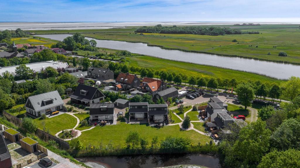 an aerial view of a home next to a river at 't Eibernest in De Cocksdorp