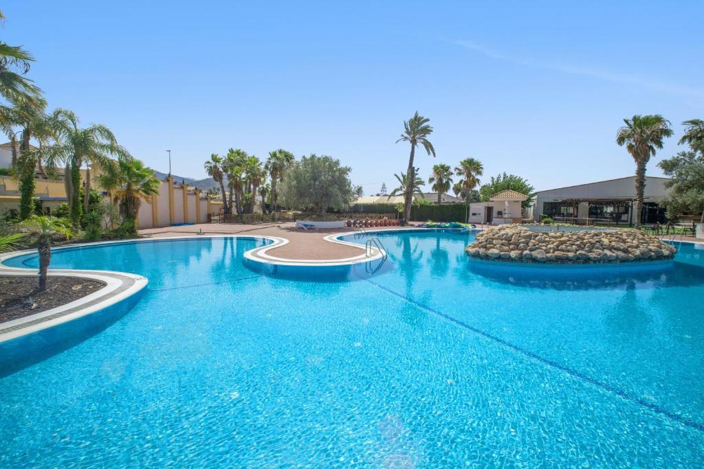a large pool with blue water in a resort at Casa Paula in Mazarrón