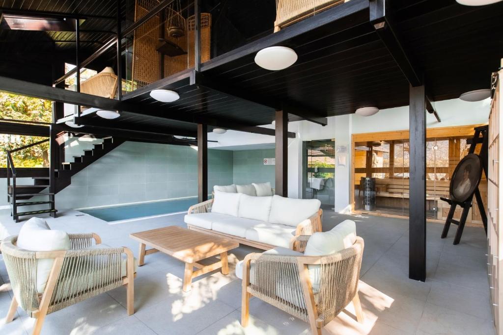 a living room with a couch and chairs and a table at Mr Görgey Art Hotel in Visegrád