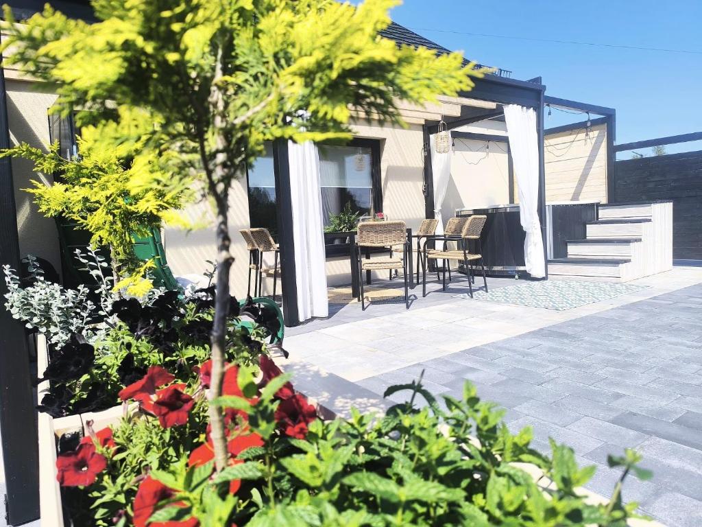 a patio with a table and chairs and plants at Bukowe Wzgórza in Trzebniów